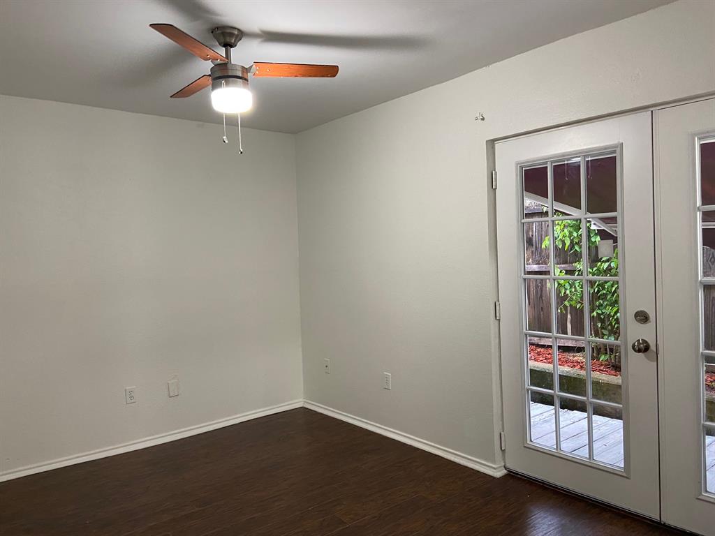 1440 Weiler Boulevard Fort Worth, TX 76112 - Photo 5 of 11 an empty room with potted plants and wooden floor