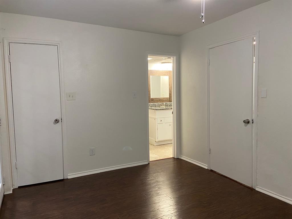 1440 Weiler Boulevard Fort Worth, TX 76112 - Photo 6 of 11 a view of an empty room with wooden floor and closet