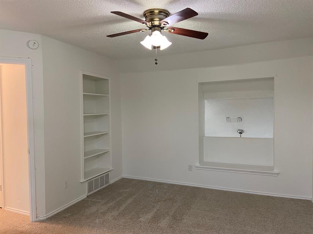 1440 Weiler Boulevard Fort Worth, TX 76112 - Photo 8 of 11 a view of an empty room with a ceiling fan