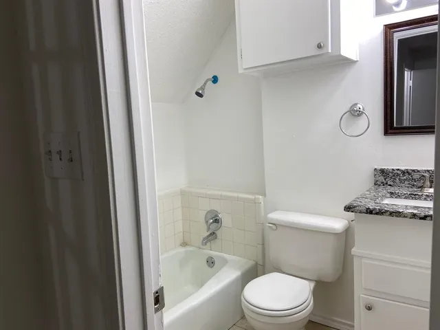 a white toilet sitting next to a bathroom sink