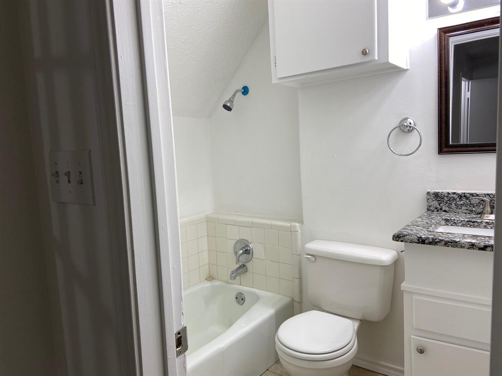 1440 Weiler Boulevard Fort Worth, TX 76112 - Photo 10 of 11 a white toilet sitting next to a bathroom sink