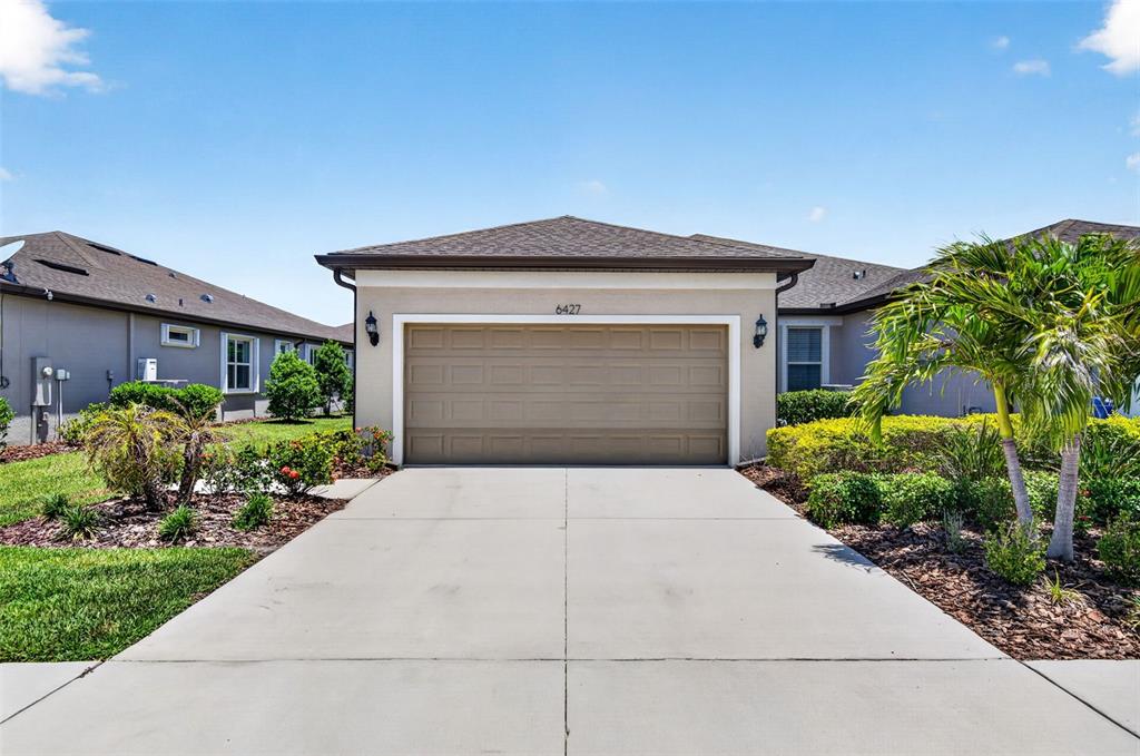 6427 Mooring Line Circle Apollo Beach, FL 33572 - Photo 1 of 34 a front view of a house with a yard and garage