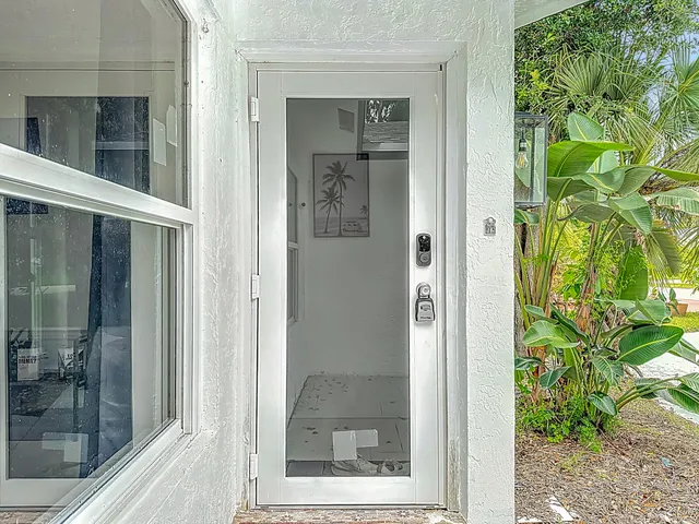 a view of a bathroom that has a glass door and a window