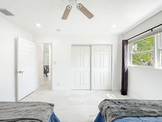 a bedroom with a bed and a window