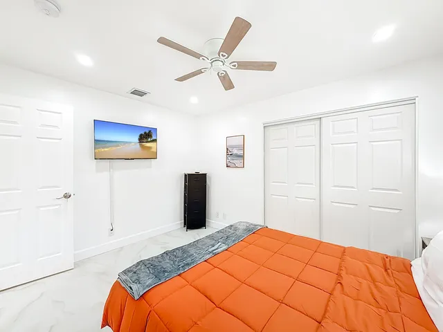 a bedroom with a bed and a chandelier