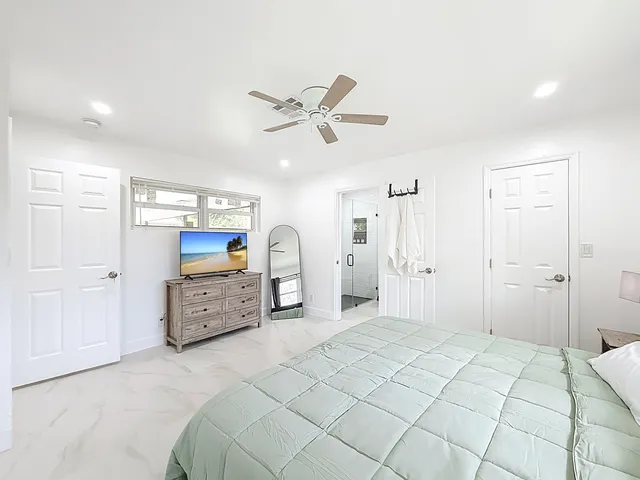 a bedroom with a bed and a dresser