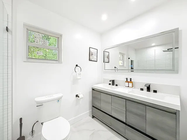a white toilet sitting next to a bathroom sink