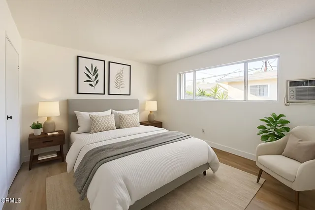 a bedroom with a bed couch and window