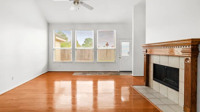 a view of an empty room with exposed radiator and fireplace