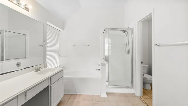 a bathroom with a shower sink and mirror