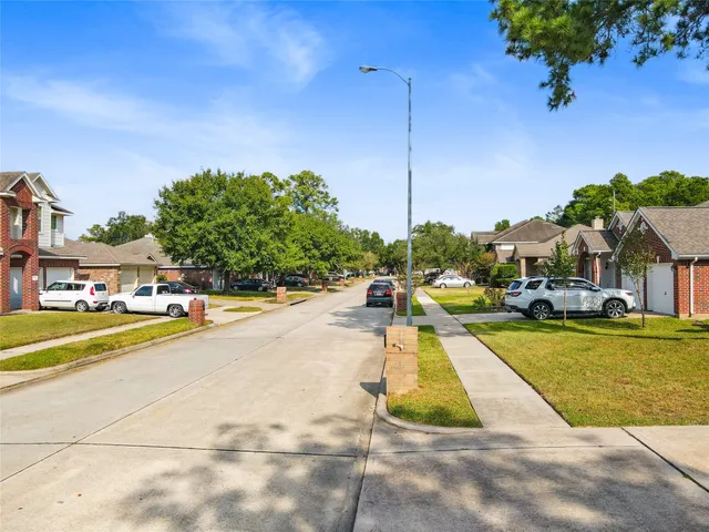 a view of swimming pool of water with lawn chairs and palm tree