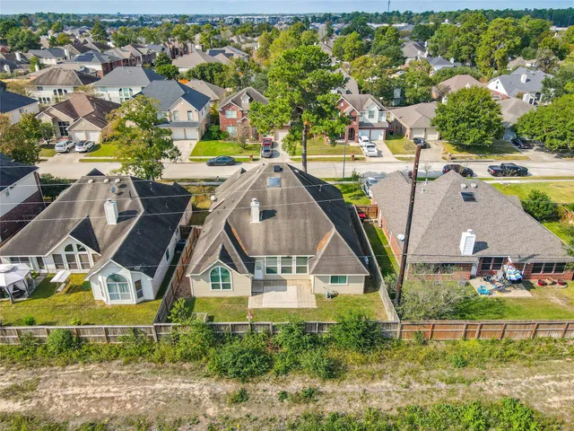 an aerial view of a house with swimming pool and outdoor space