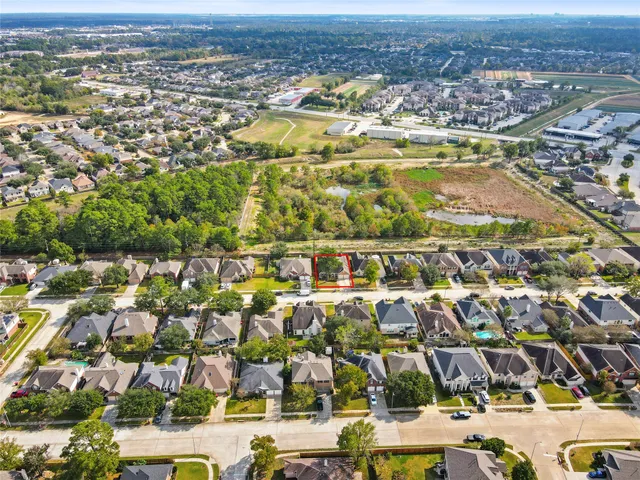 an aerial view of residential houses with outdoor space