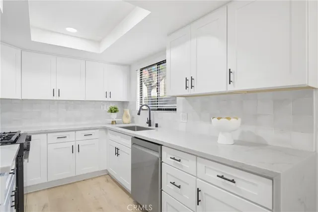 a kitchen with white cabinets and a sink