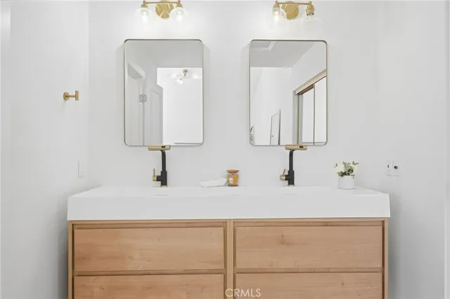 a bathroom with a sink vanity and mirror