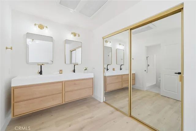 a bathroom with a sink a toilet and mirror