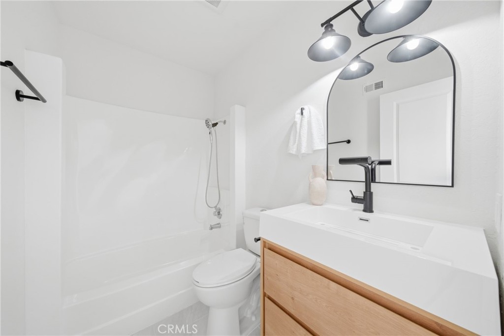 2714 Via Colina, Unit 12 Fullerton, CA 92835 - Photo 27 of 32 a bathroom with a sink a toilet and shower