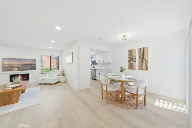 a living room with furniture and a dining table with wooden floor