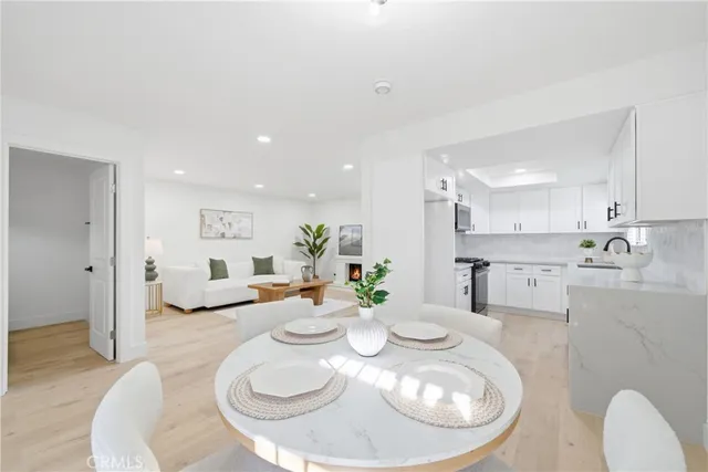 a open dining room with furniture and wooden floor