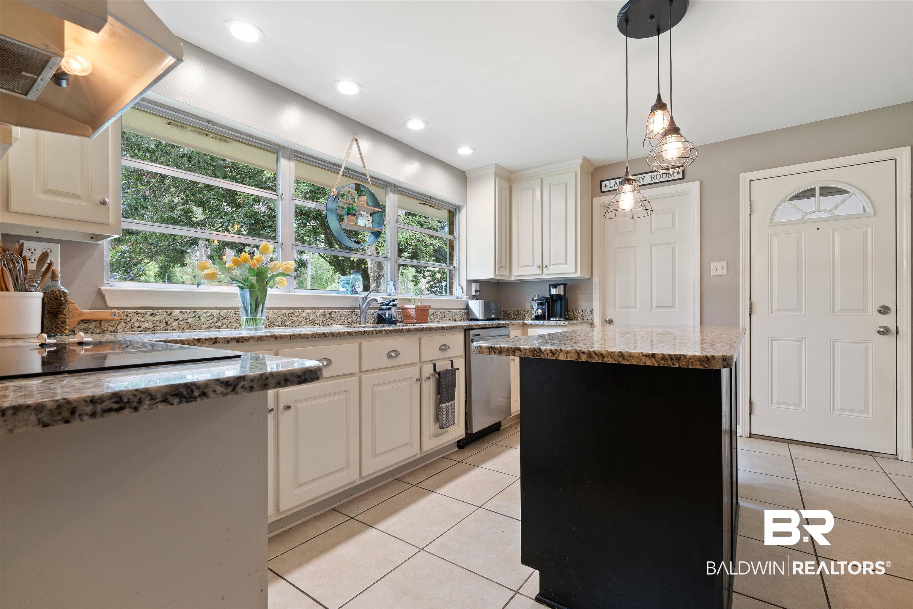 4051 East Canal Circle Mobile, AL 36619 - Photo 9 of 32 Kitchen with stone counters, exhaust hood, dishwasher, and light tile patterned floors