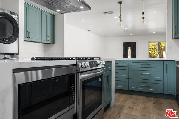 a kitchen with a stove and a sink