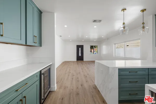 a view of a kitchen center island with wooden floor