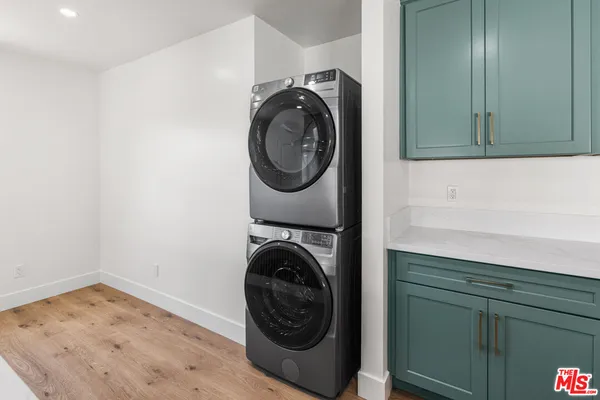 a utility room with sink dryer and washer