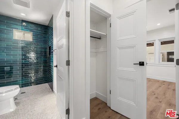 a bathroom with a toilet and a shower