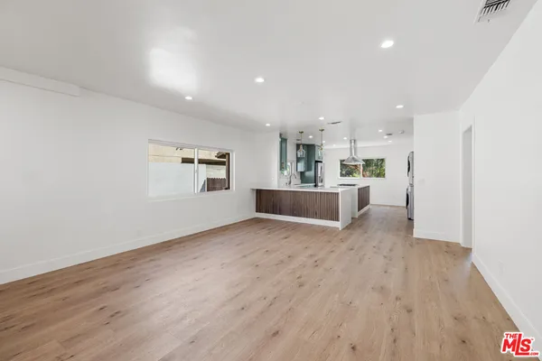 a view of a kitchen with a sink and a stove top oven