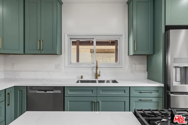 a kitchen with a refrigerator and a sink