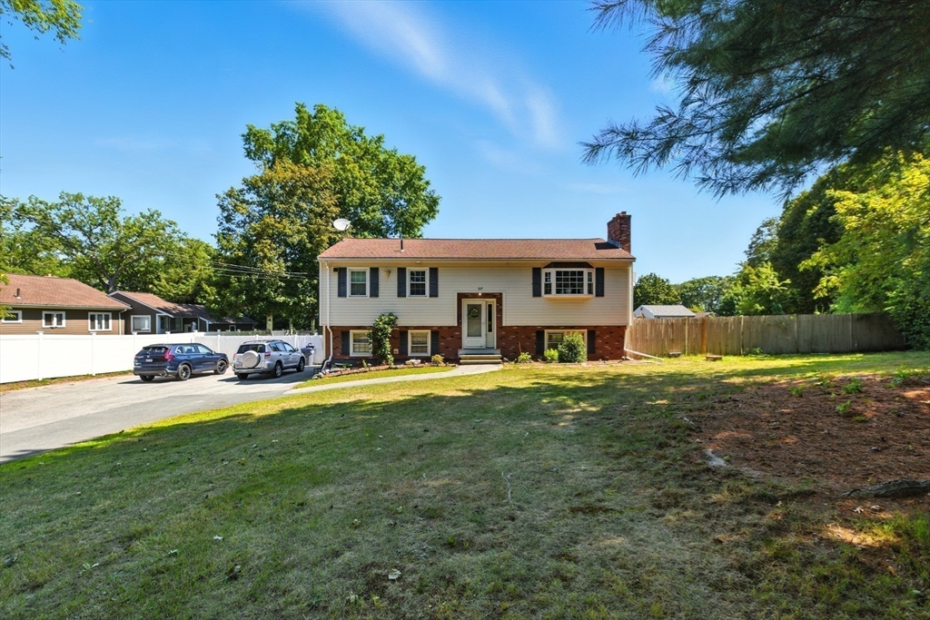 a view of a house with pool and a yard