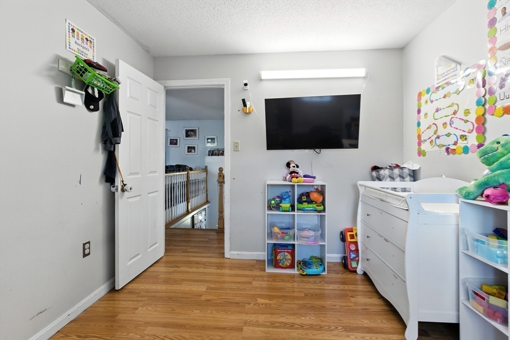 169 Berkeley Street Methuen, MA 01844 - Photo 13 of 31 a room with furniture and a flat screen tv