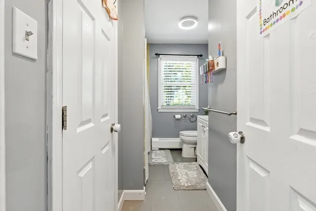 a bathroom with a toilet sink and a mirror