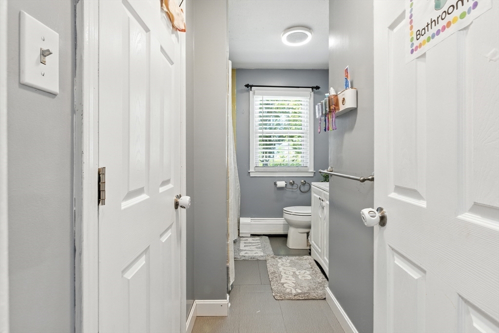 169 Berkeley Street Methuen, MA 01844 - Photo 14 of 31 a bathroom with a toilet sink and a mirror