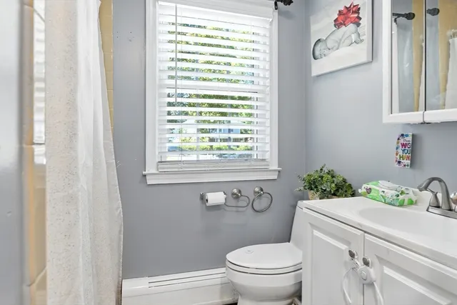 a bathroom with a toilet sink and window