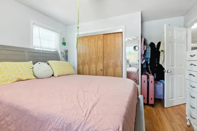 a bedroom with a bed and a window