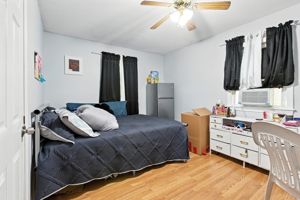 169 Berkeley Street Methuen, MA 01844 - Photo 18 of 31 a bedroom with a bed and a flat screen tv