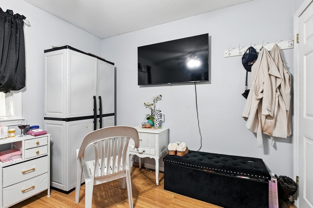 169 Berkeley Street Methuen, MA 01844 - Photo 19 of 31 a living room with furniture and a flat screen tv