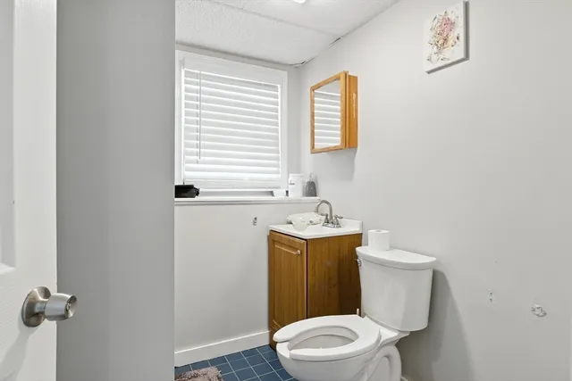 a white toilet sitting next to a bathroom sink