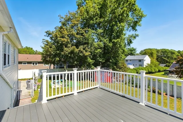 a view of a wooden deck and a yard