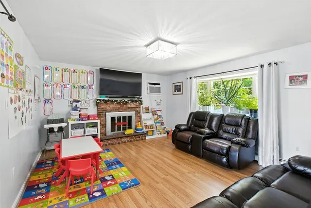 a living room with furniture a flat screen tv and a fireplace