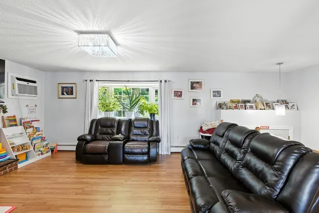 a living room with furniture fireplace and a window