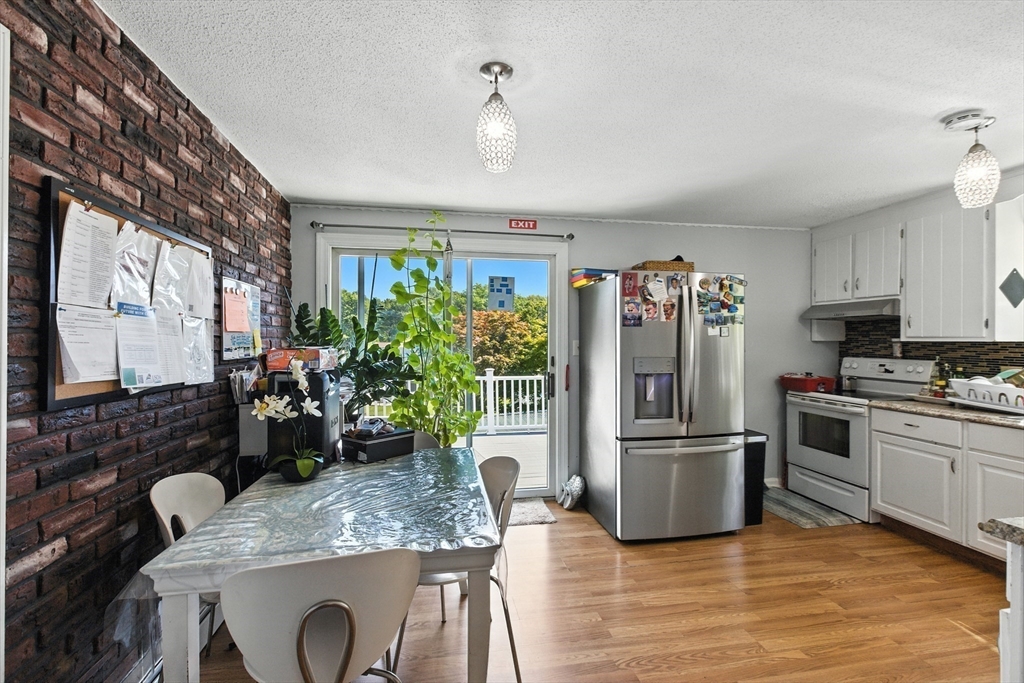 169 Berkeley Street Methuen, MA 01844 - Photo 7 of 31 a kitchen with refrigerator and sink