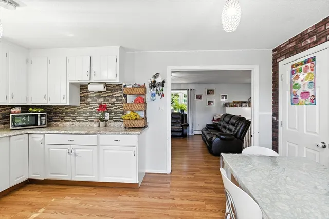 a kitchen with granite countertop a stove a sink and a refrigerator