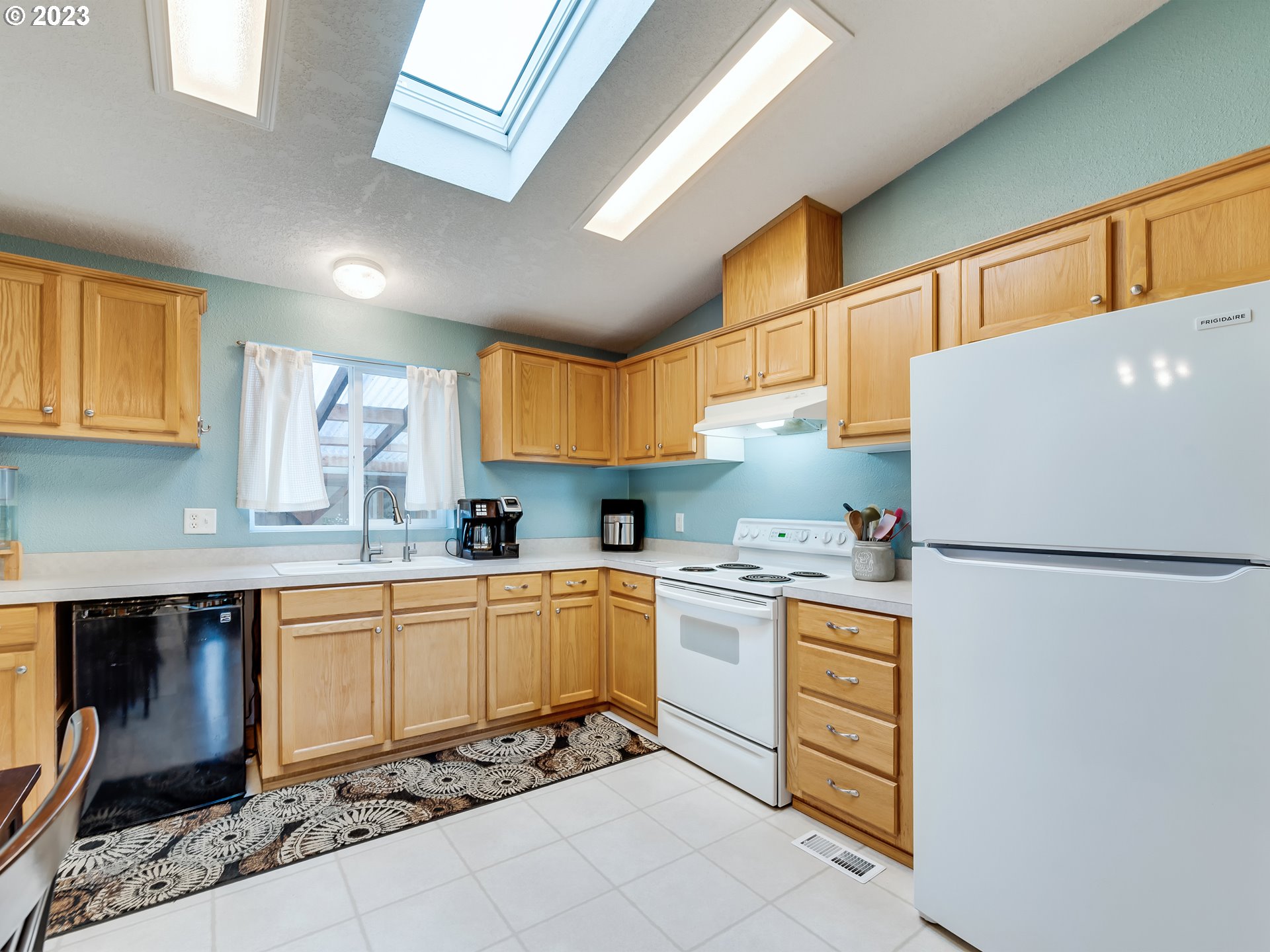 29720 Jeans Road, Unit 22 Veneta, OR 97487 - Photo 11 of 30 a kitchen with a refrigerator a stove top oven a sink and cabinets