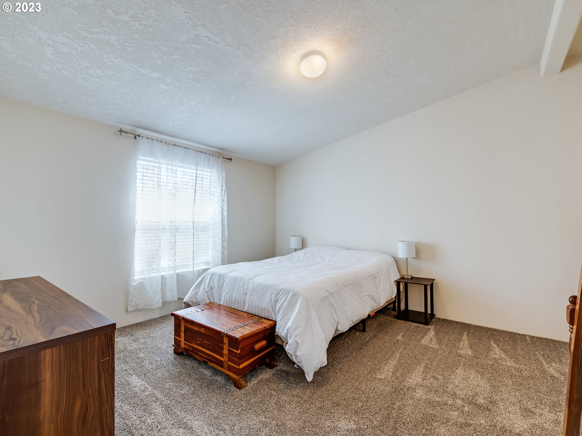 29720 Jeans Road, Unit 22 Veneta, OR 97487 - Photo 16 of 30 a bedroom with a bed and a window