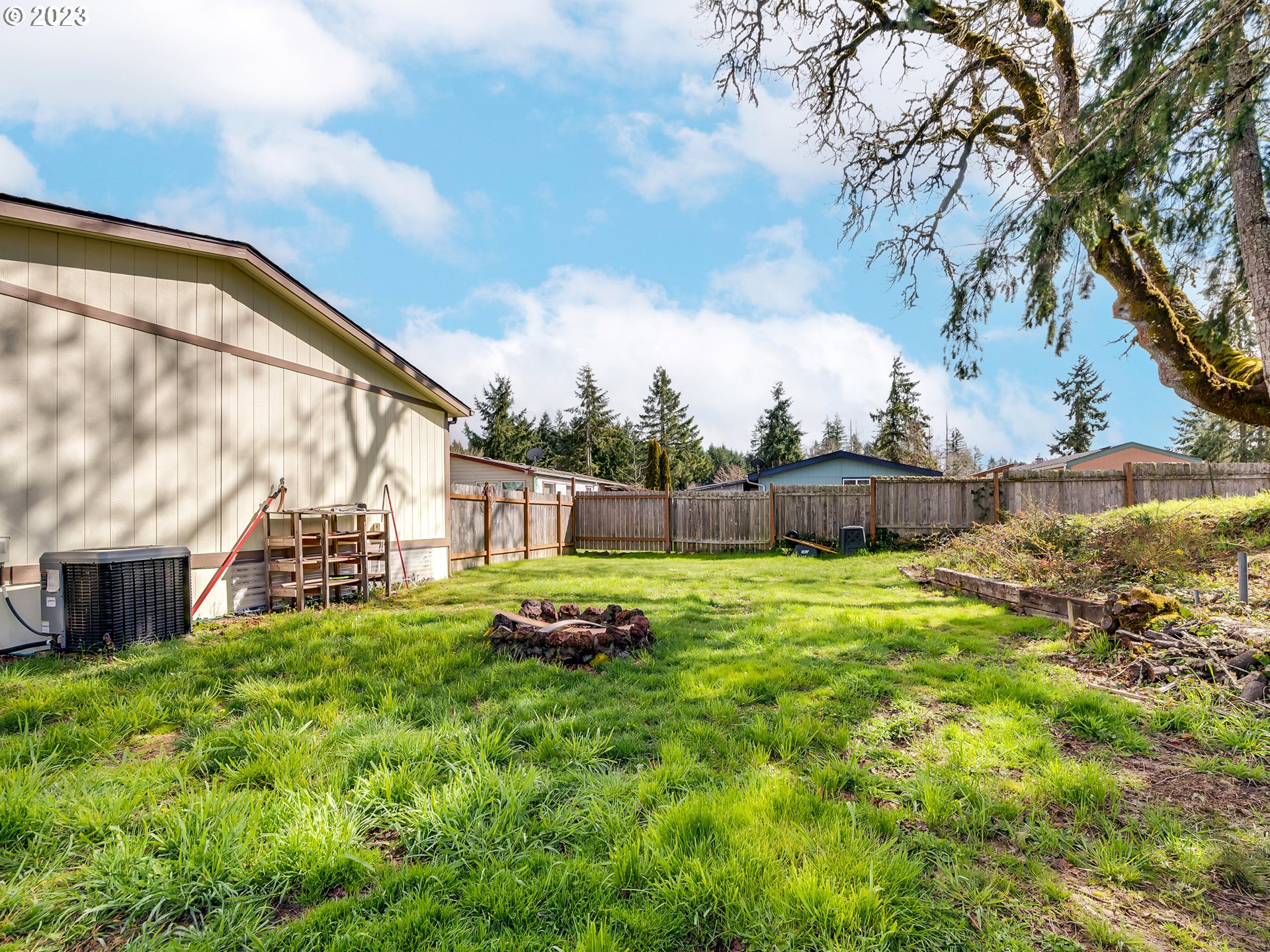 29720 Jeans Road, Unit 22 Veneta, OR 97487 - Photo 22 of 30 a view of a backyard with plants and a large tree