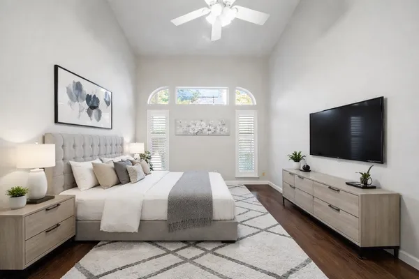a bedroom with bed and a flat screen tv