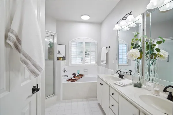 a bathroom with a tub sink and mirror