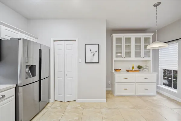 a kitchen with stainless steel appliances a refrigerator and cabinets